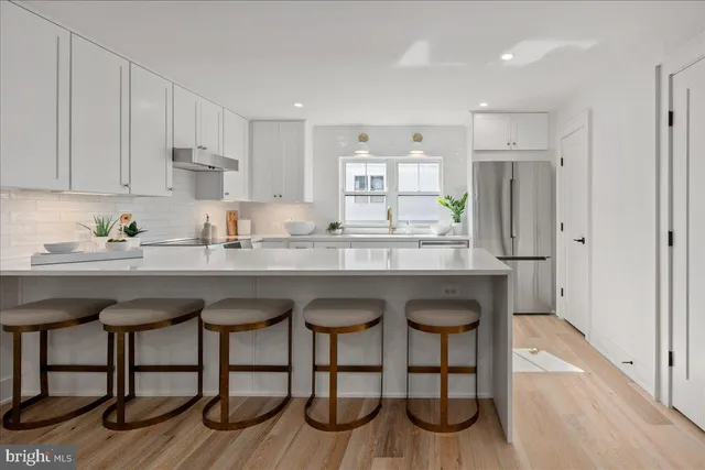 a kitchen with cabinets a sink and appliances
