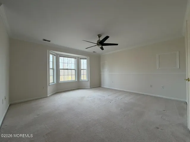 a view of a livingroom with a ceiling fan and window