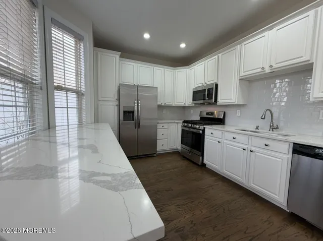a kitchen with refrigerator a sink and cabinets