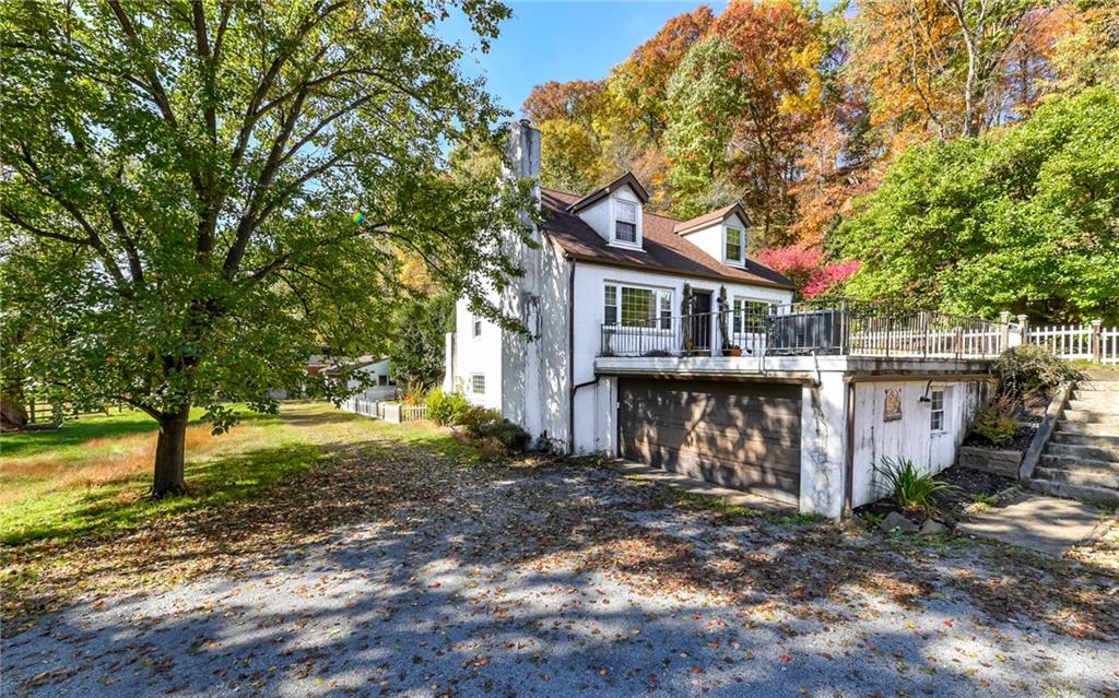 a view of a house with a yard and tree s