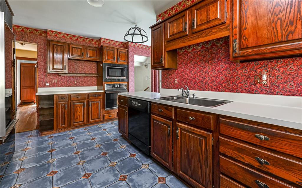 2065 Fairhill Road Sewickley, PA 15143 - Photo 9 of 45 a kitchen with stainless steel appliances granite countertop a sink and cabinets