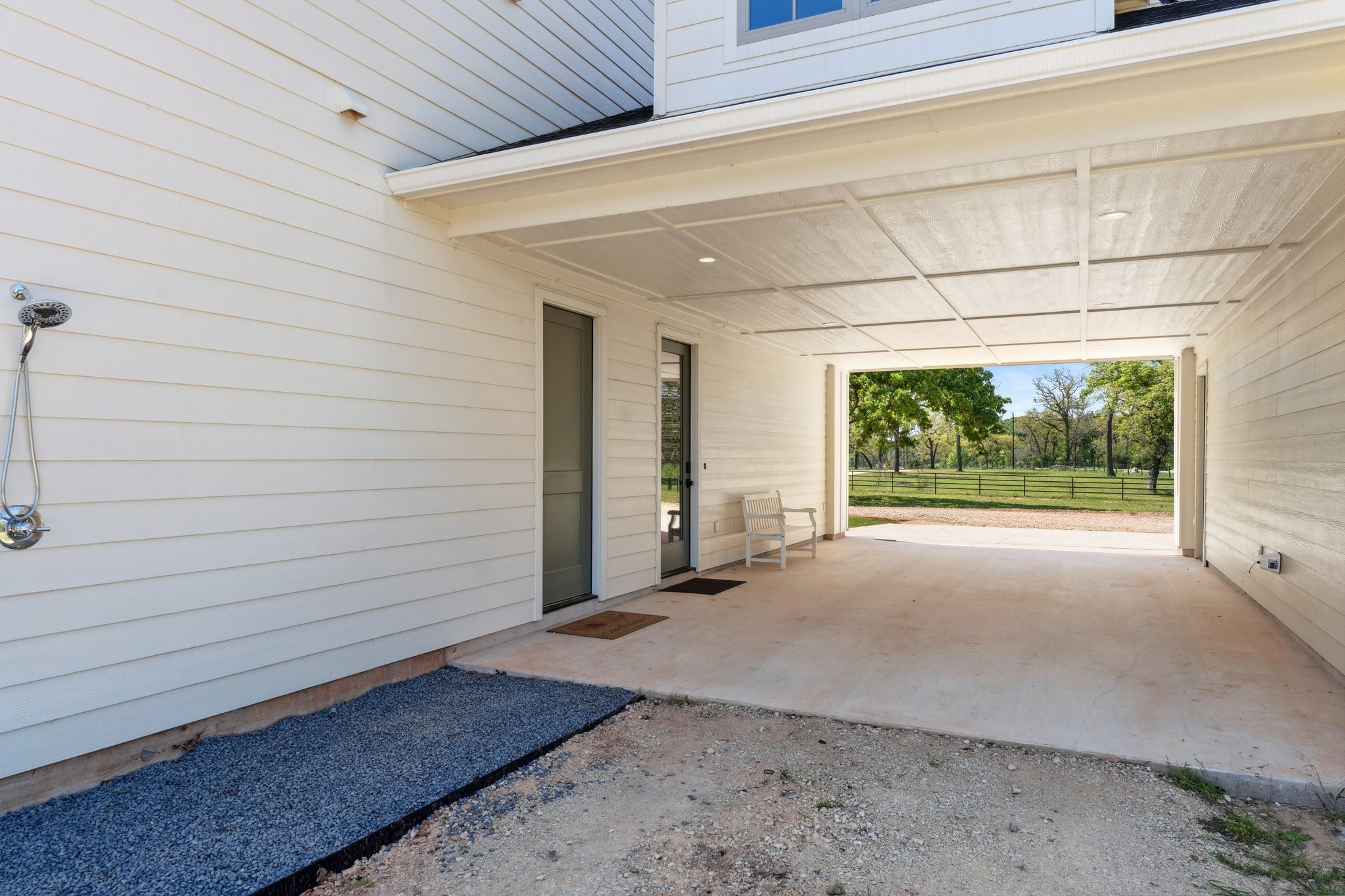 4052 Kuykendall Road Bellville, TX 77418 - Photo 34 of 40 Seamless convenience with this home's adjacent porte-cochere and refreshing outdoor shower, perfect for easy transitions and outdoor enjoyment.