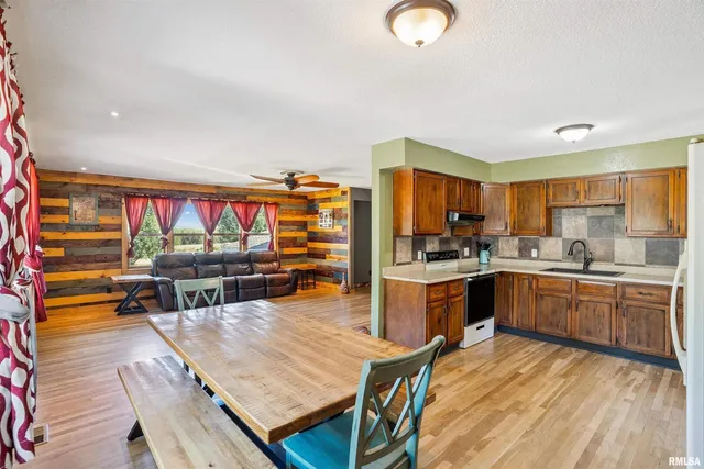 a kitchen with stainless steel appliances granite countertop a stove and cabinets