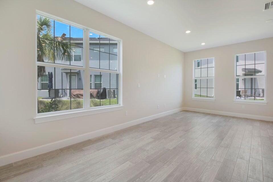 1875 Southeast Ocean Cove Way Stuart, FL 34996 - Photo 12 of 37 a view of an empty room with a window and wooden floor