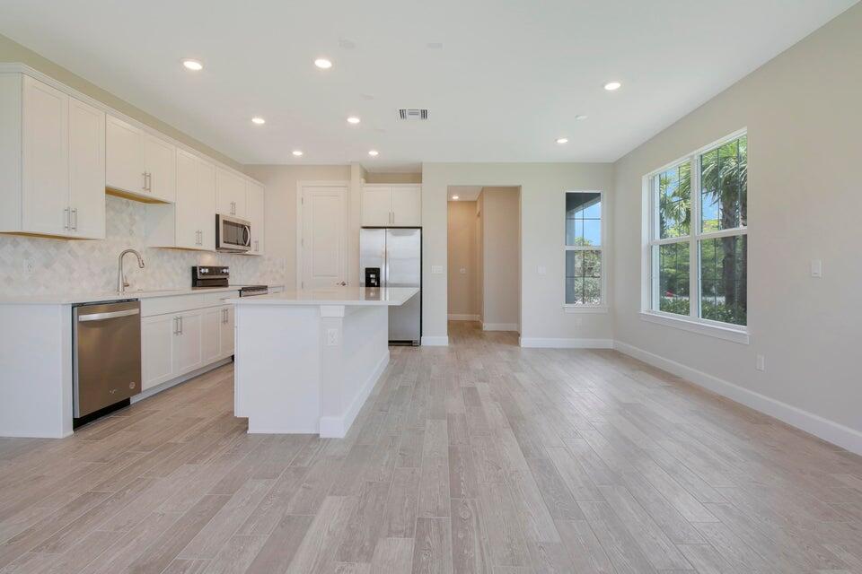 1875 Southeast Ocean Cove Way Stuart, FL 34996 - Photo 13 of 37 a view of kitchen with wooden floor and electronic appliances