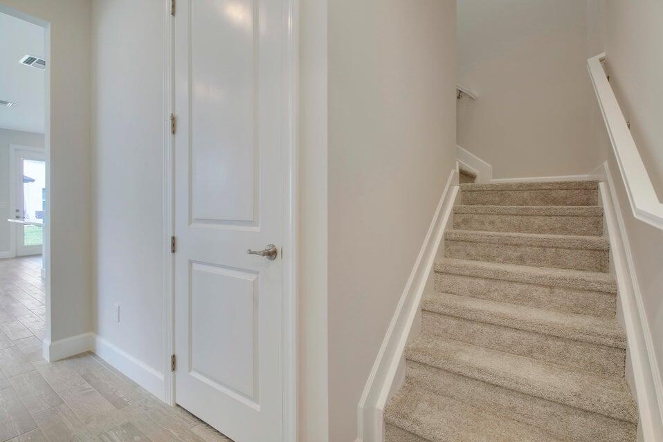 1875 Southeast Ocean Cove Way Stuart, FL 34996 - Photo 20 of 37 a view of staircase with white walls and white door