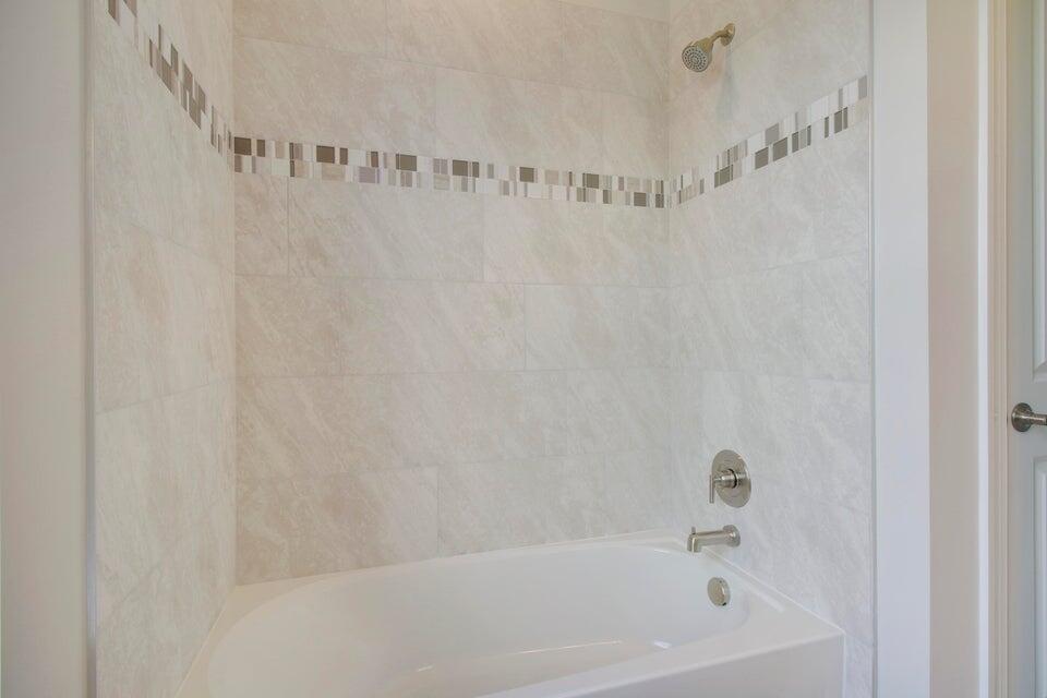 1875 Southeast Ocean Cove Way Stuart, FL 34996 - Photo 32 of 37 a bathroom with a bathtub