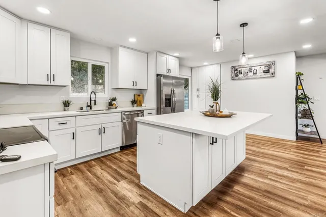 a kitchen with a sink stove and cabinets