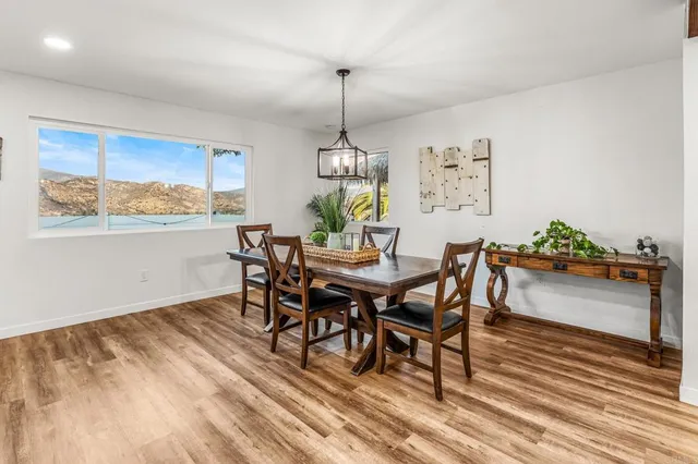a dining room with furniture a rug and wooden floor