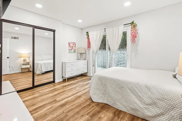 a bedroom with a bed and a large window