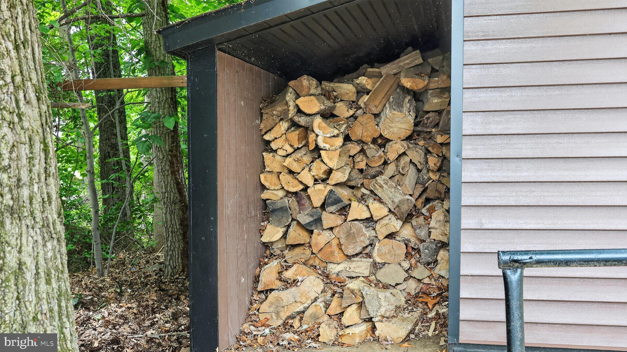 5325 Hammond Road New Holland, PA 17557 - Photo 60 of 73 Woodpile nestled in nature's embrace.