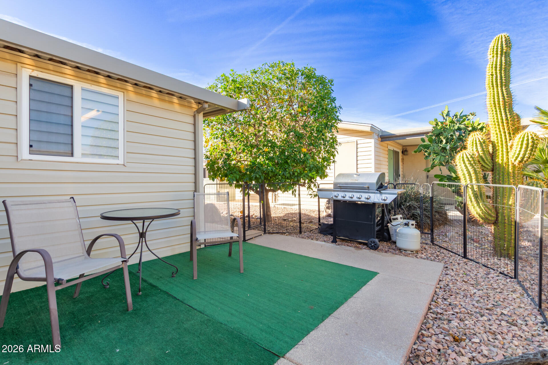 3301 South Goldfield Road, Unit 4086 Apache Junction, AZ 85119 - Photo 30 of 41 a view of a chair and table in the backyard