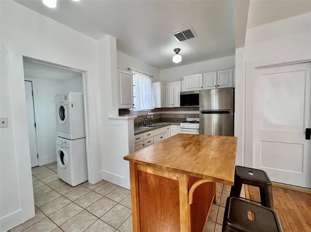 a kitchen with stainless steel appliances a refrigerator sink and microwave