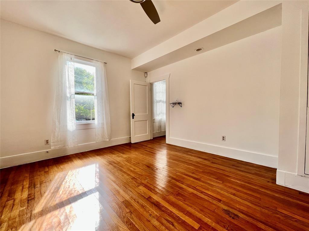 207 West 45th Street, Unit B Austin, TX 78751 - Photo 6 of 10 an empty room with wooden floor and windows