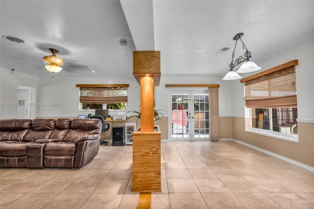 a living room with furniture and a chandelier