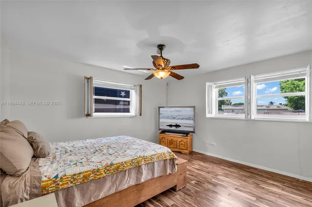 a bedroom with a bed dresser and a window