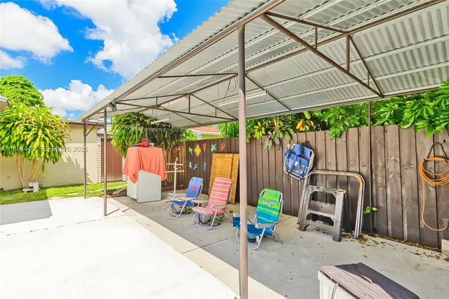 a view of a chairs and table under an umbrella