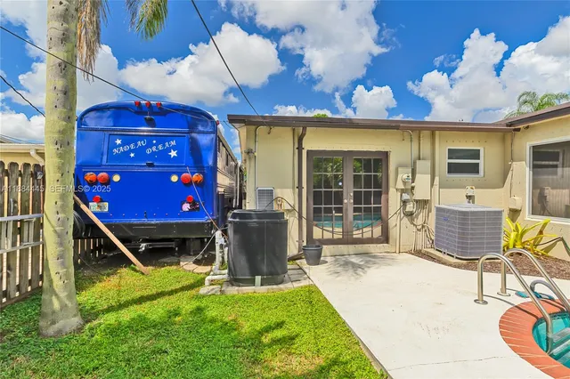 a front view of a house with swimming pool outdoor seating and yard