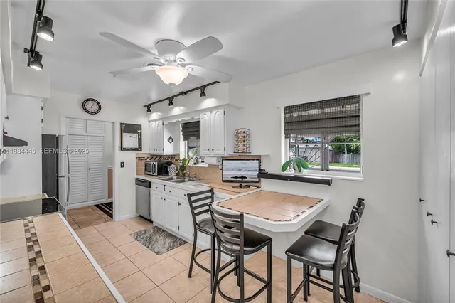 a view of a dining room with furniture and a chandelier