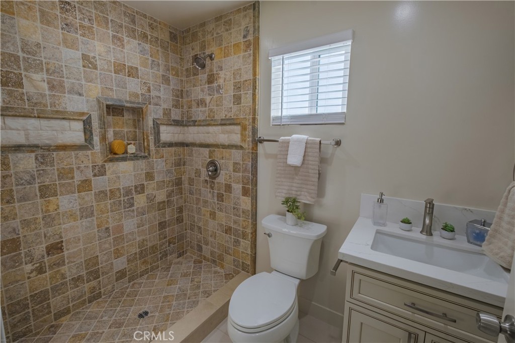 223 South Aprilia Avenue Compton, CA 90220 - Photo 39 of 46 a white toilet sitting next to a bathroom sink