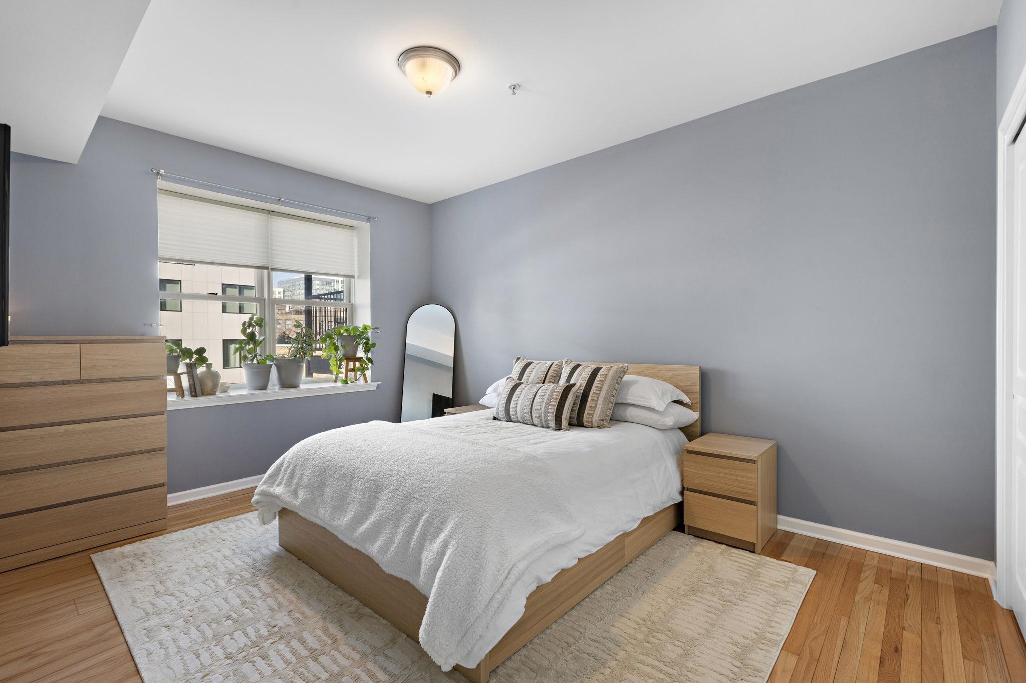 612 Adams Street, Unit 4 Hoboken, NJ 07030 - Photo 1 of 14 a bedroom with a large bed and a window