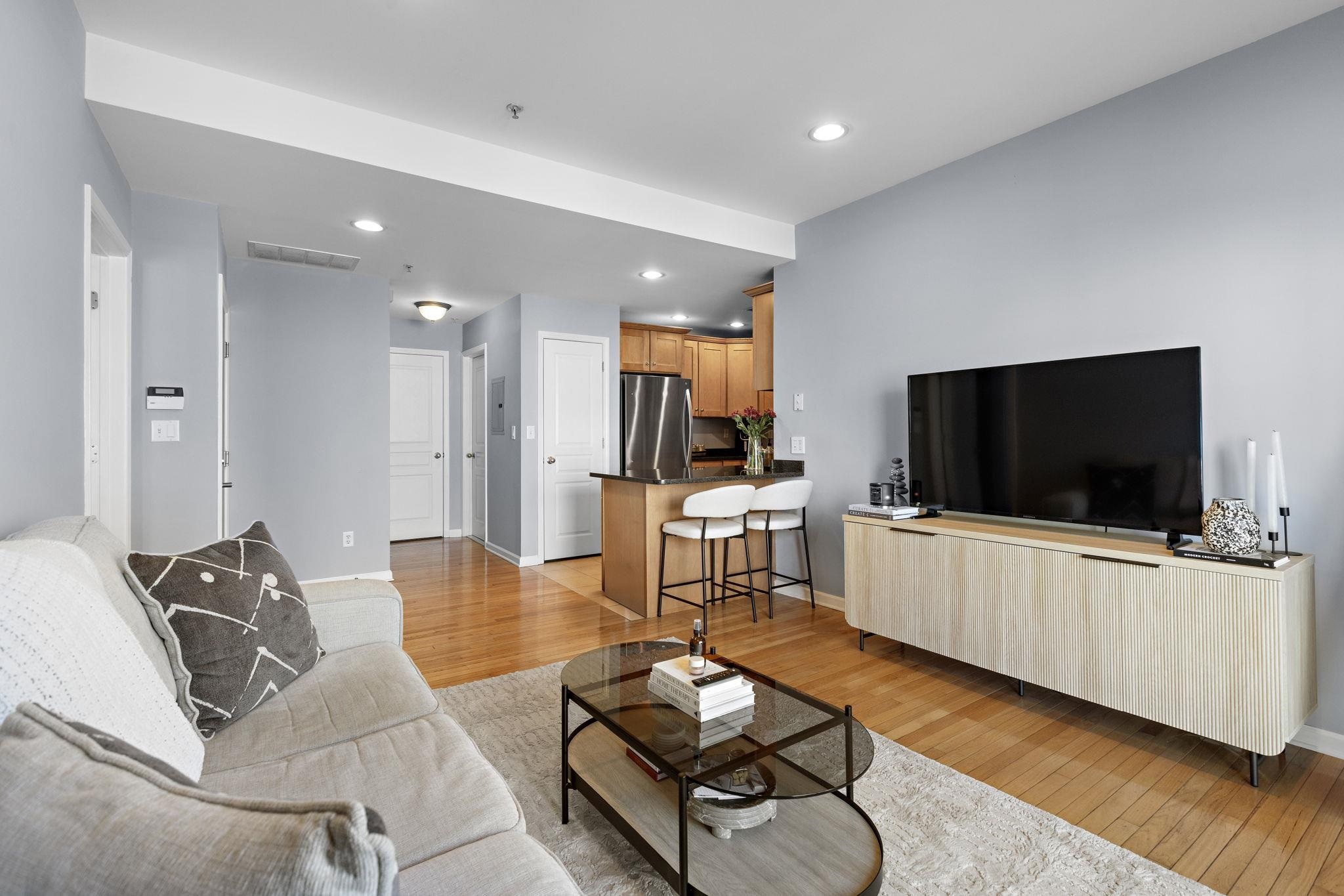 612 Adams Street, Unit 4 Hoboken, NJ 07030 - Photo 3 of 14 a living room with furniture and a flat screen tv