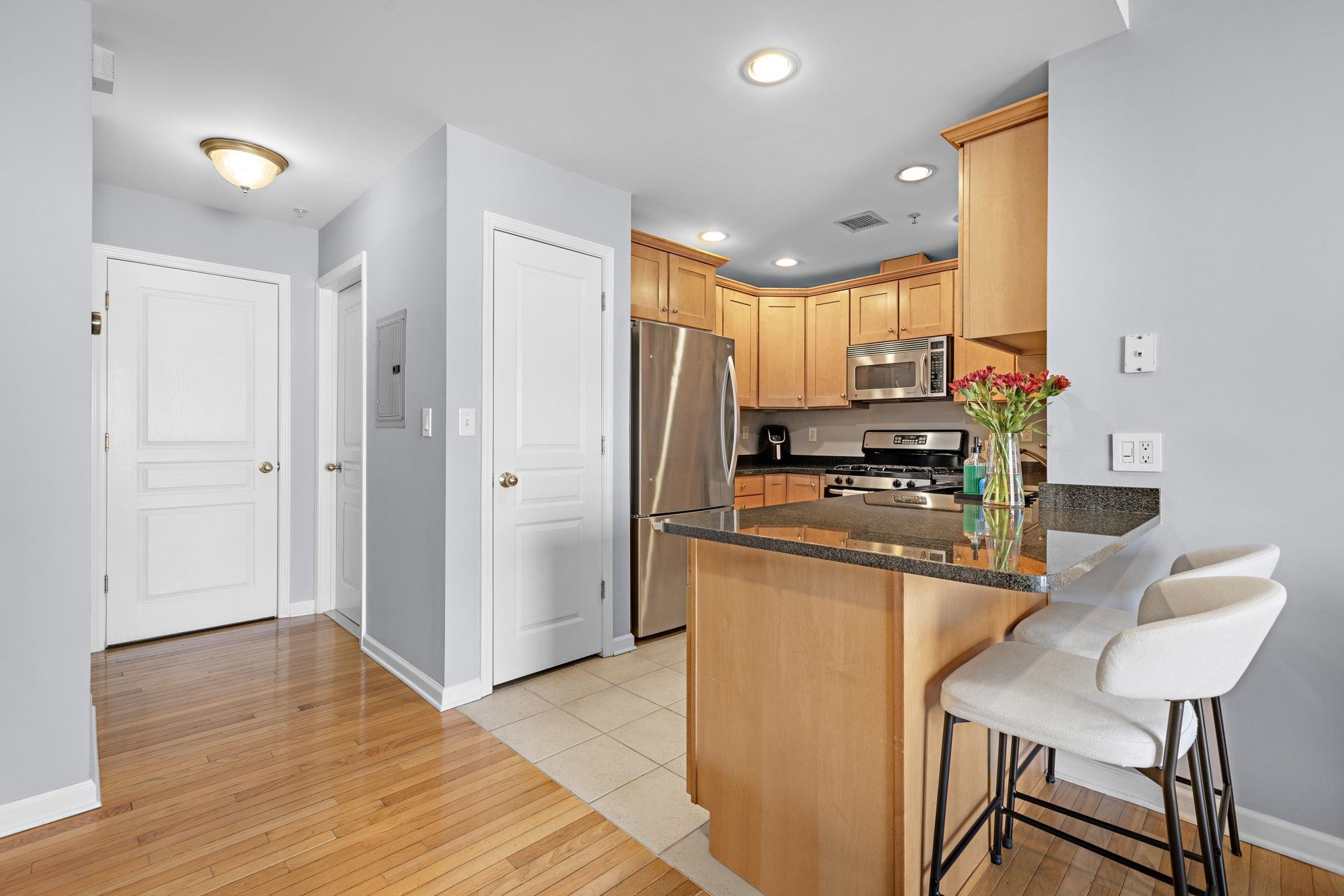 612 Adams Street, Unit 4 Hoboken, NJ 07030 - Photo 5 of 14 a kitchen with stainless steel appliances granite countertop a refrigerator and a stove top oven