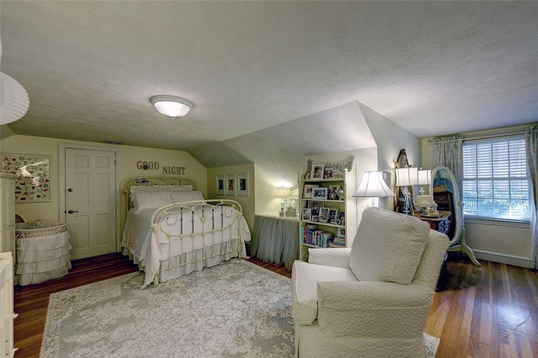 2894 Mendon Road Cumberland, RI 02864 - Photo 29 of 39 Upstairs bedroom. The window faces onto the back yard. Door next to bed leads to attic access.