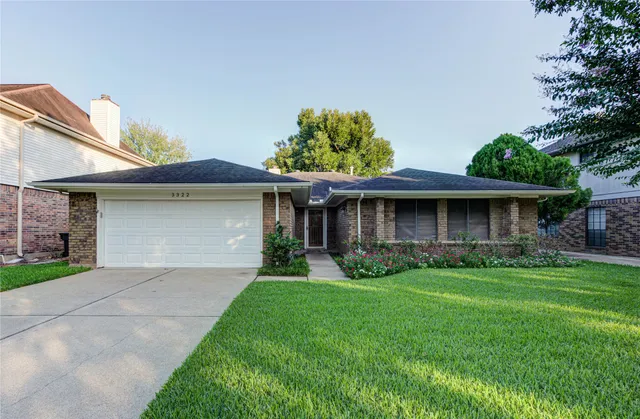 a front view of a house with a garden and plants