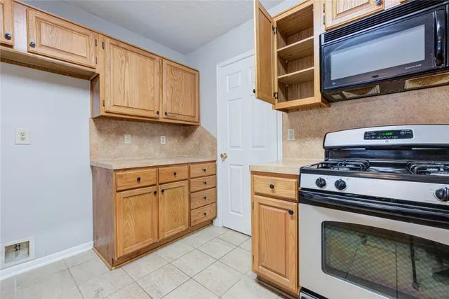 a utility room with a sink a window and a mirror