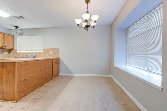 a kitchen with stainless steel appliances a refrigerator and a stove top oven