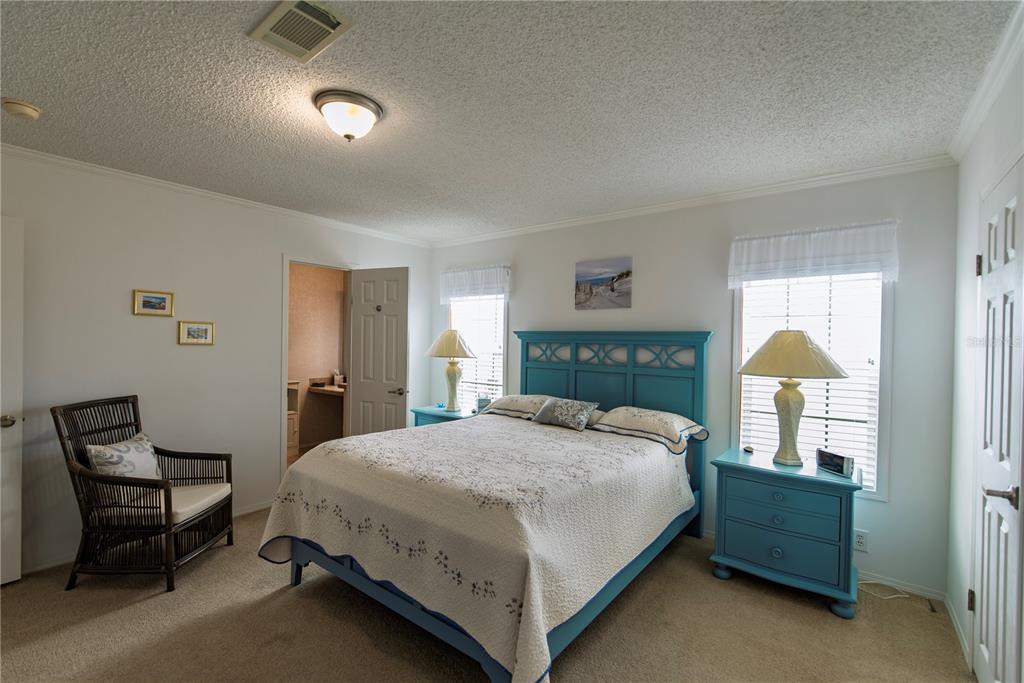 36 Freeman Avenue Punta Gorda, FL 33950 - Photo 11 of 27 a bedroom with a bed and a chair