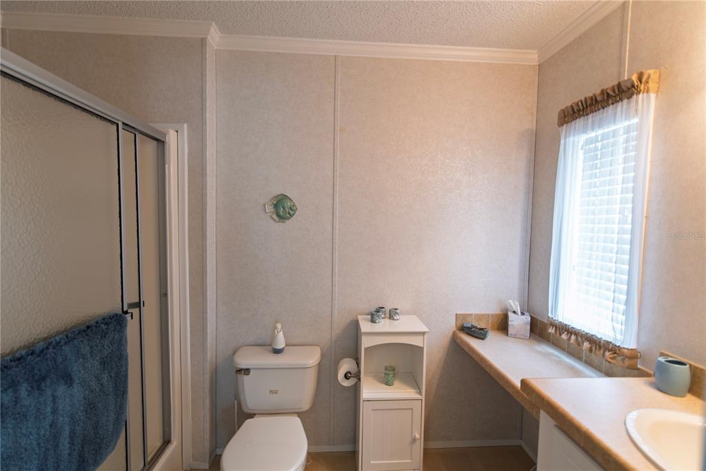 36 Freeman Avenue Punta Gorda, FL 33950 - Photo 13 of 27 a bathroom with a sink a toilet and a mirror