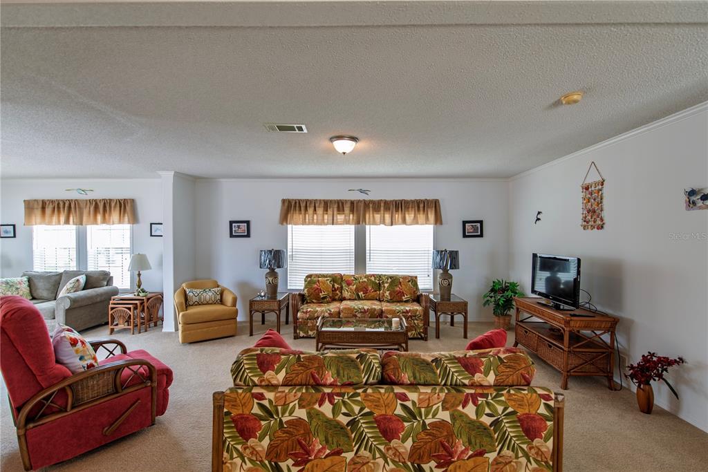 36 Freeman Avenue Punta Gorda, FL 33950 - Photo 4 of 27 a living room with furniture large window and a flat screen tv