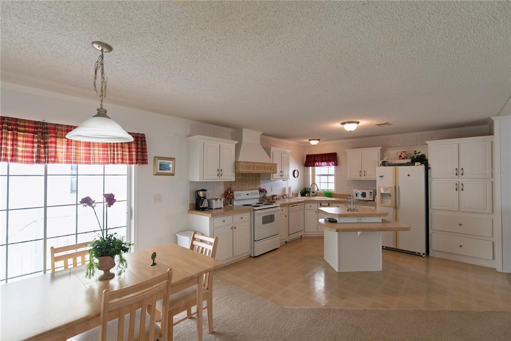 36 Freeman Avenue Punta Gorda, FL 33950 - Photo 5 of 27 a kitchen with stainless steel appliances kitchen island granite countertop a sink stove and refrigerator