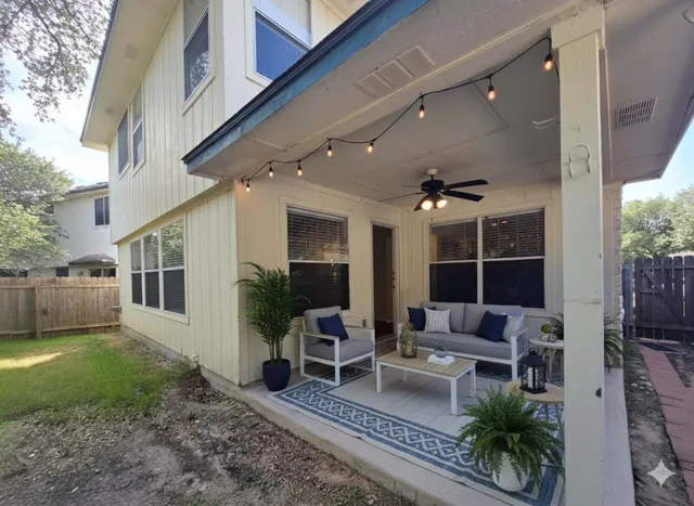 a view of a house with furniture and a yard