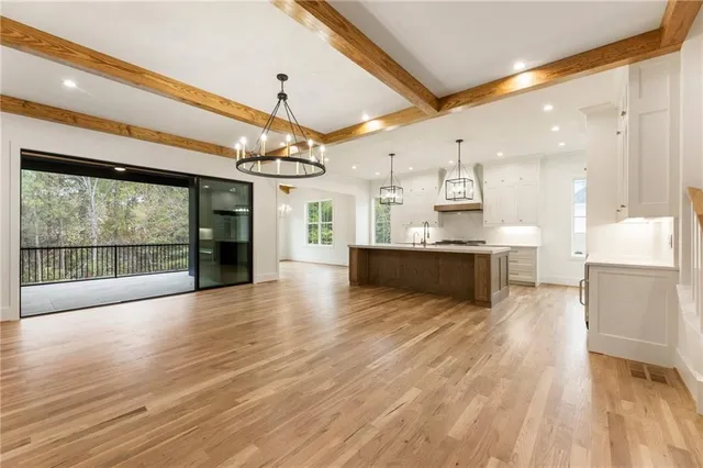 a kitchen with kitchen island a sink stainless steel appliances and cabinets
