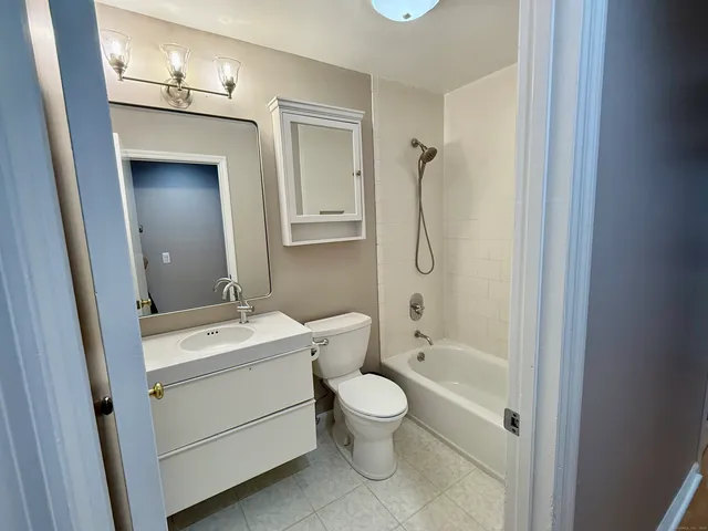 a bathroom with a toilet a sink and shower