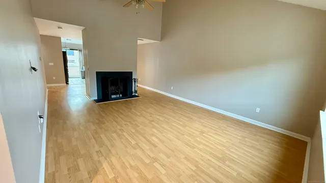 a view of an empty room with a fireplace