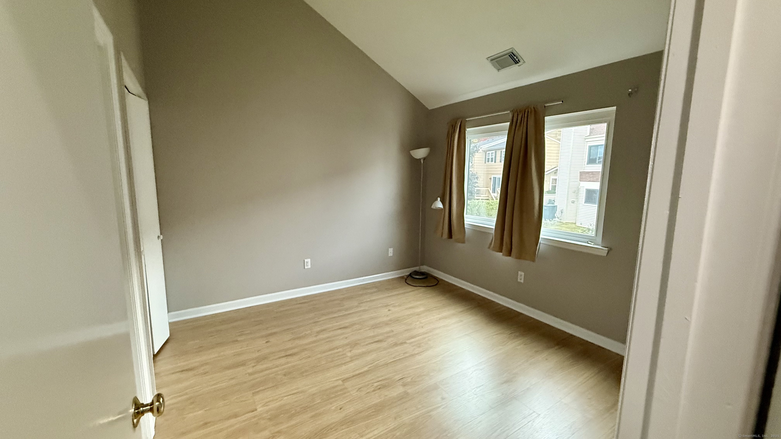 34 Nature View Trail, Unit 34 Bethel, CT 06801 - Photo 10 of 19 a view of an empty room with wooden floor and a window