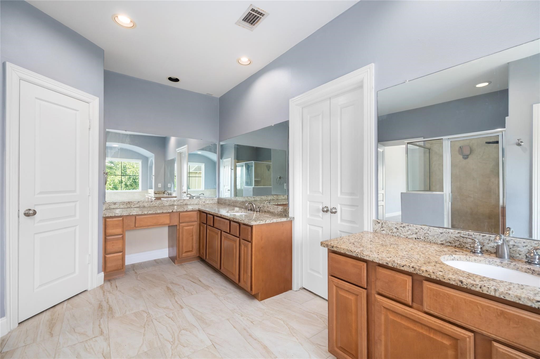 53 Versante Court Houston, TX 77070 - Photo 18 of 30 a bathroom with granite countertop double vanity and a mirror