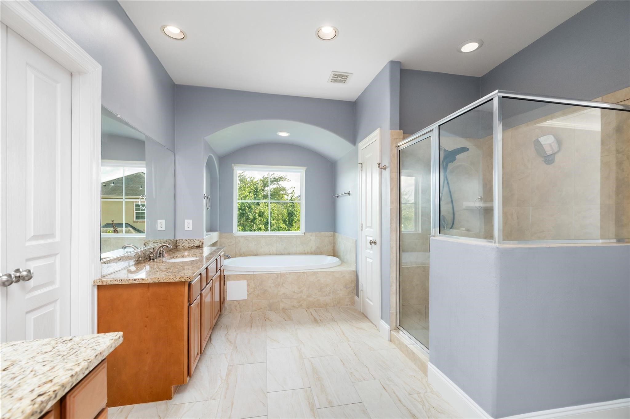 53 Versante Court Houston, TX 77070 - Photo 19 of 30 a bathroom with a granite countertop tub sink and mirror