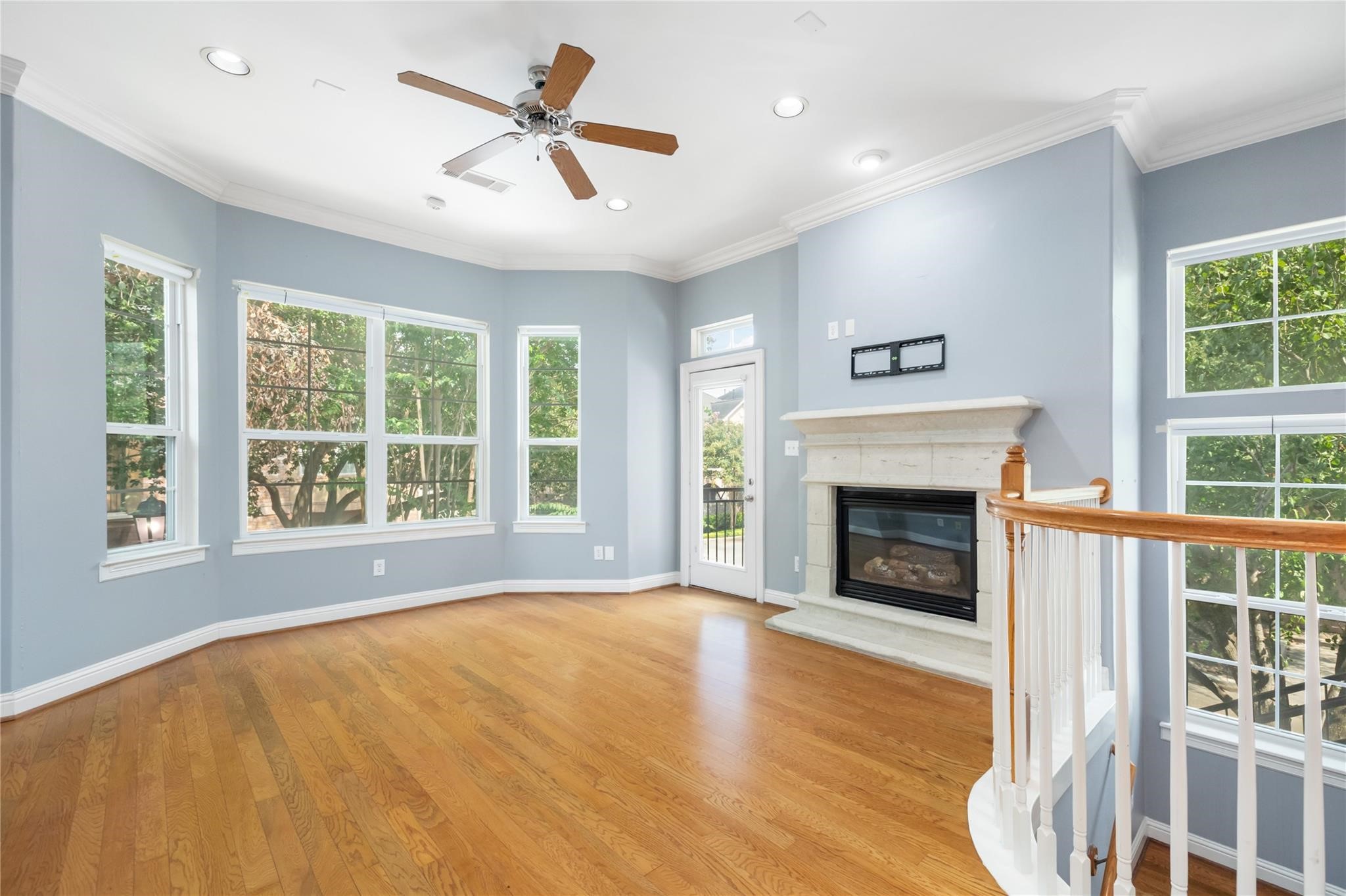 53 Versante Court Houston, TX 77070 - Photo 5 of 30 a view of empty room with wooden floor and a fireplace