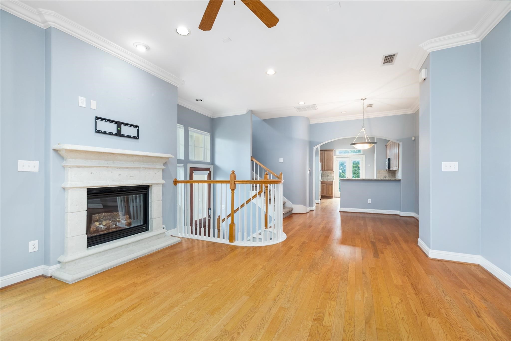 53 Versante Court Houston, TX 77070 - Photo 8 of 30 a view of an empty room with wooden floor and a fireplace