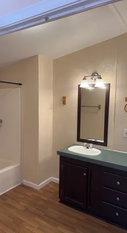 a room with a mirror and a wooden floor