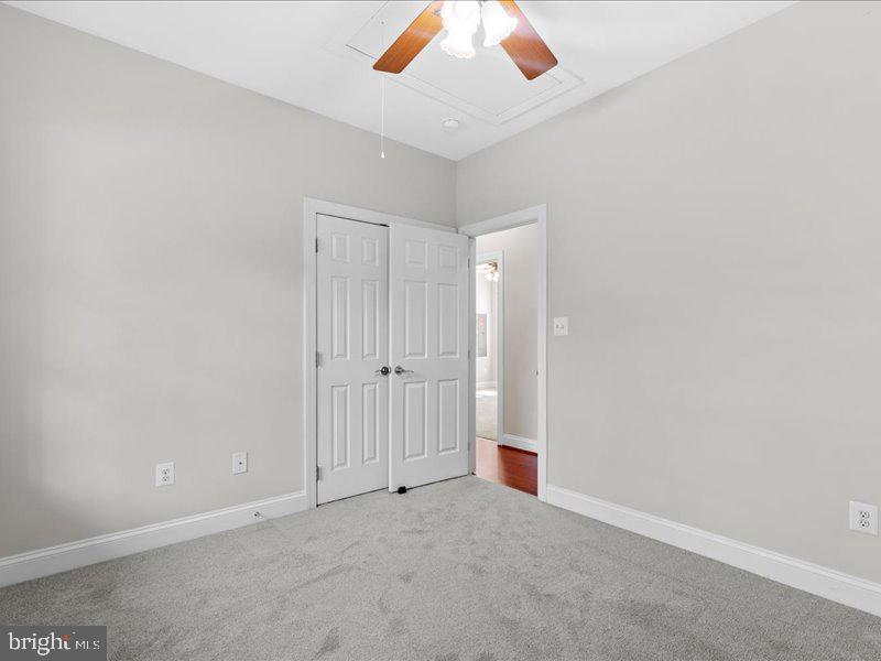 16665 Three Notch Road Ridge, MD 20680 - Photo 25 of 38 an empty room with a ceiling fan and bathroom
