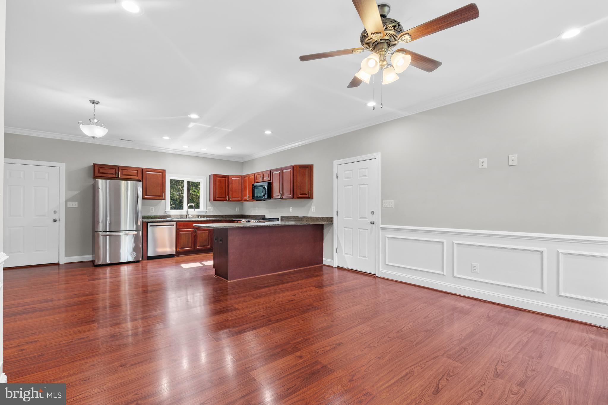 16665 Three Notch Road Ridge, MD 20680 - Photo 3 of 38 a living room with stainless steel appliances kitchen island wooden floors and kitchen view