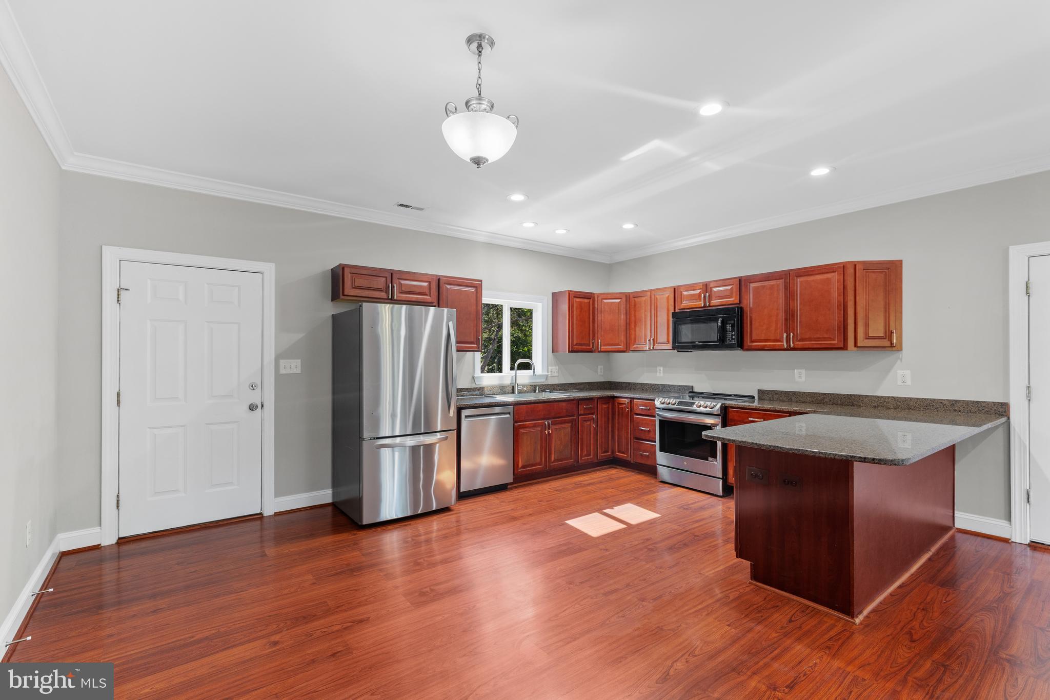 16665 Three Notch Road Ridge, MD 20680 - Photo 9 of 38 a kitchen with stainless steel appliances granite countertop a refrigerator a sink dishwasher a stove with wooden floors