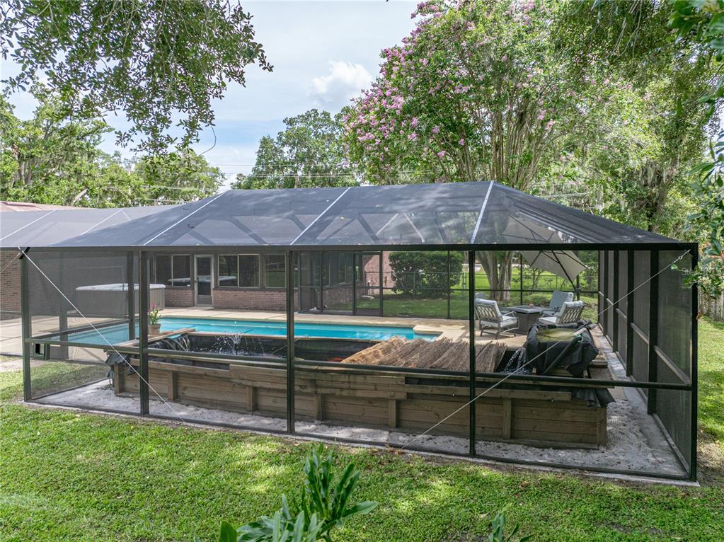 609 West Pipkin Road Lakeland, FL 33813 - Photo 59 of 72 a backyard of a house with barbeque oven table and chairs