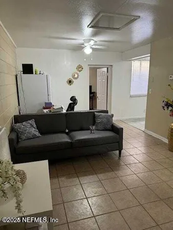 a living room with a couch and a potted plant